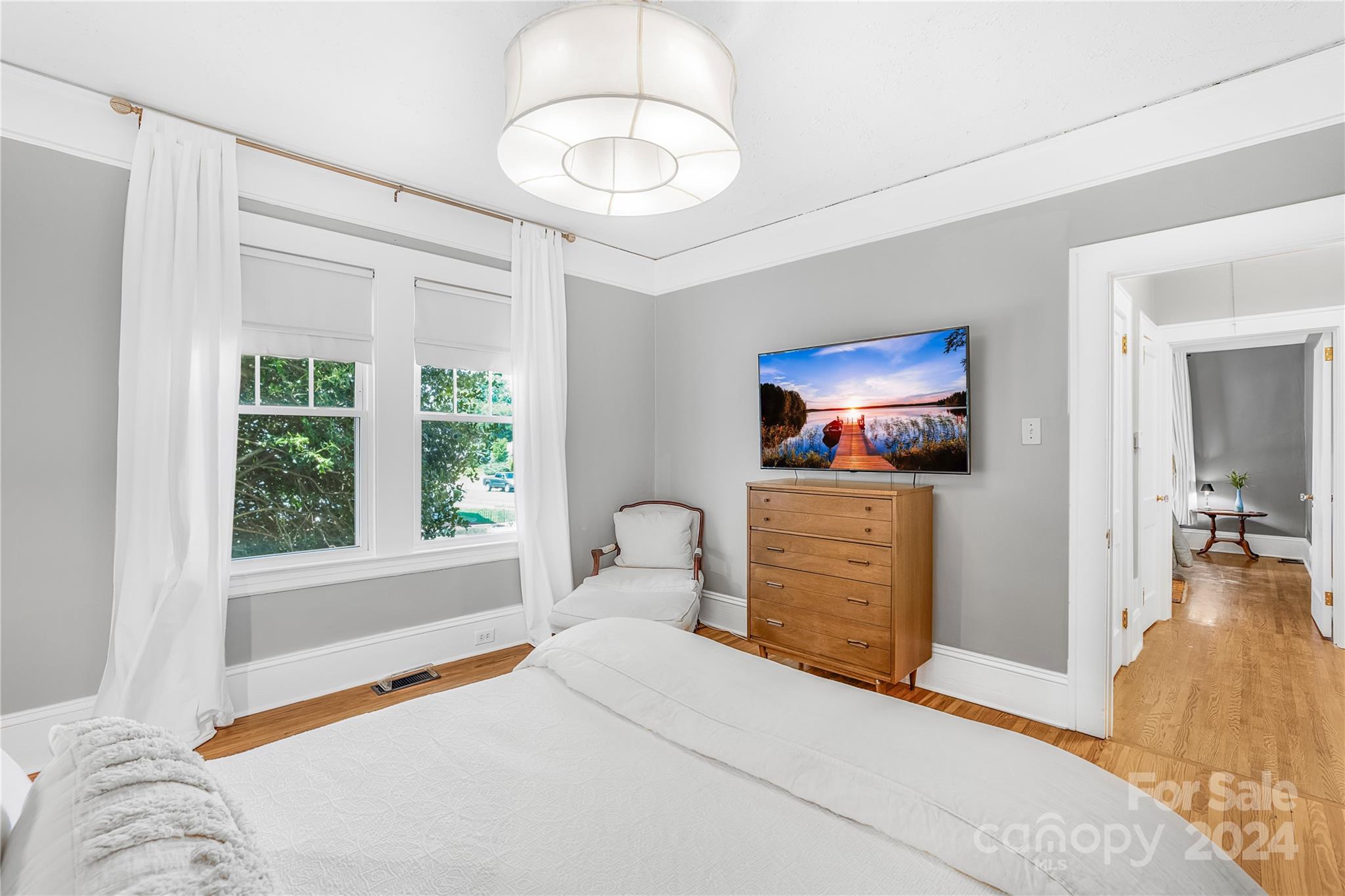 2135 Scott Avenue Charlotte, NC 28203 - Photo 33 of 48 a bedroom with a bed and a chandelier