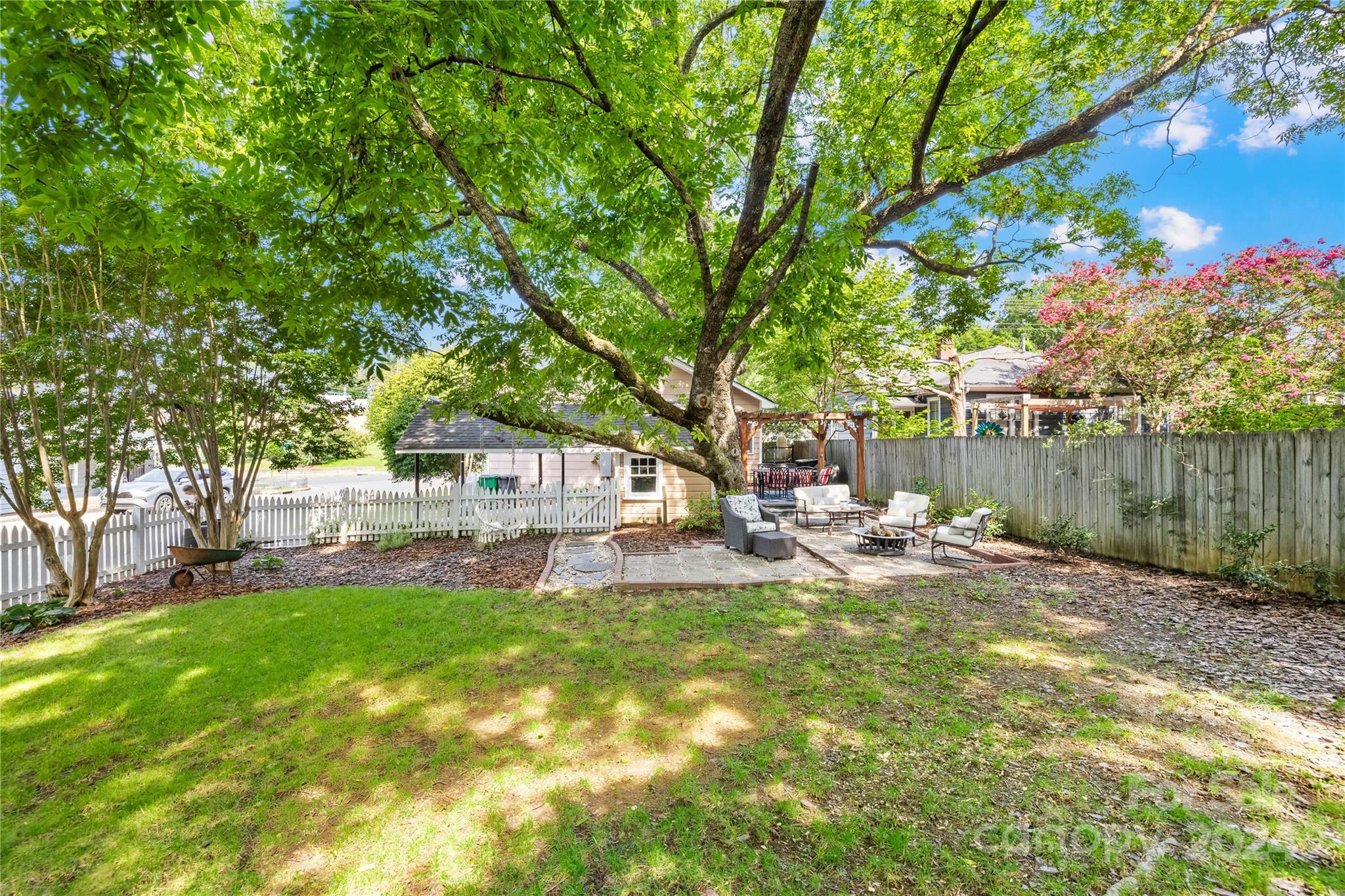 2135 Scott Avenue Charlotte, NC 28203 - Photo 37 of 48 a view of backyard with table and chairs and wooden fence