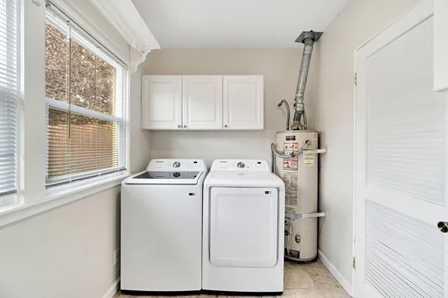 a view of a storage & utility room with dryer and washer