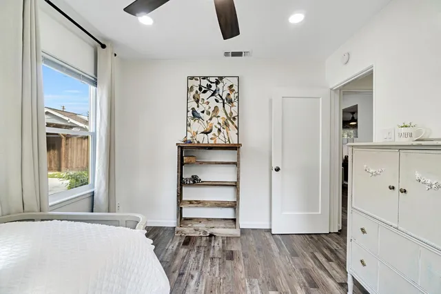 a view of a hallway with wooden floor and entryway