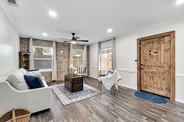 a living room with furniture and large windows