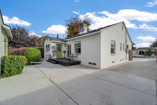 a view of a white house with a yard