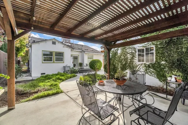 a view of a patio with table and chairs and potted plants