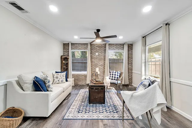 a living room with furniture and wooden floor