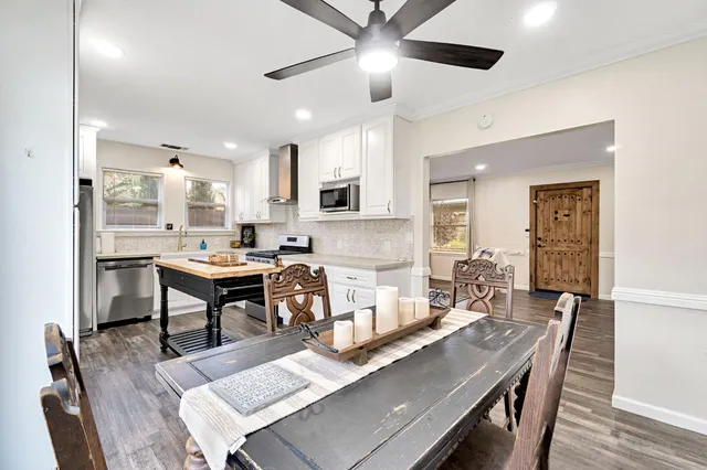 a view of a dining room with furniture and a chandelier