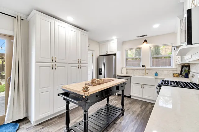 a kitchen with a table chairs and a refrigerator