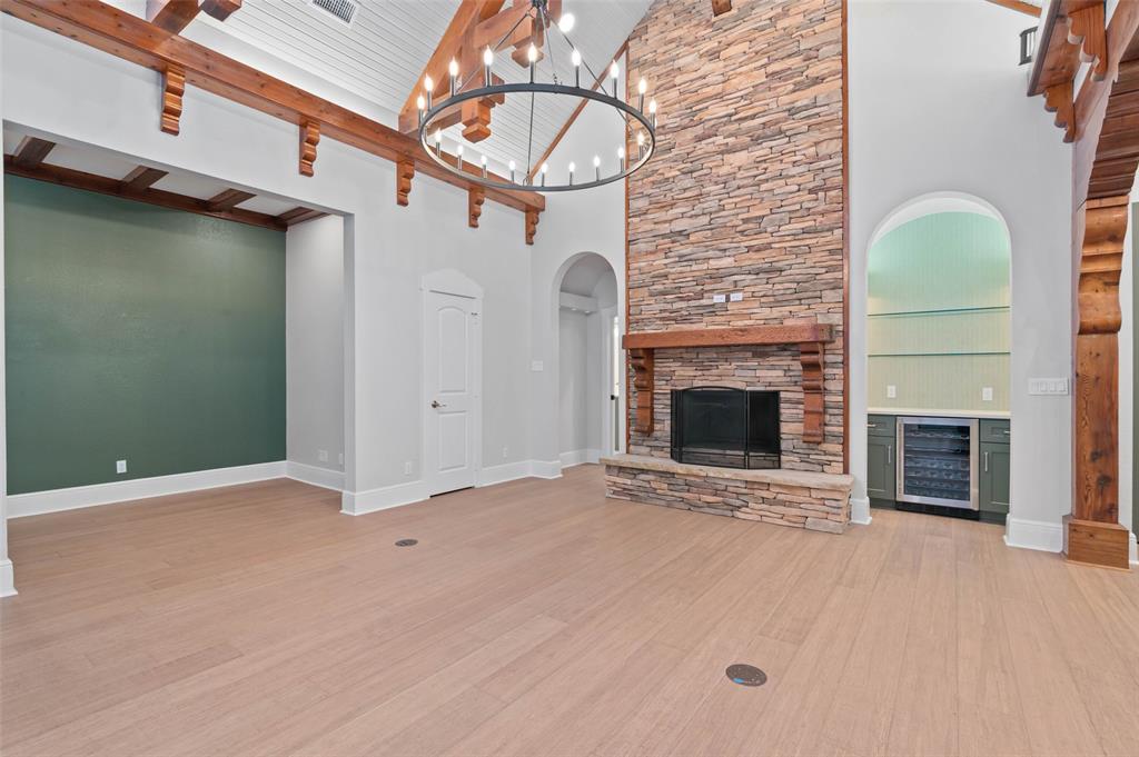 124 Garza Road Shady Shores, TX 76208 - Photo 9 of 40 Grand stone fireplace, dry bar with beverage fridge