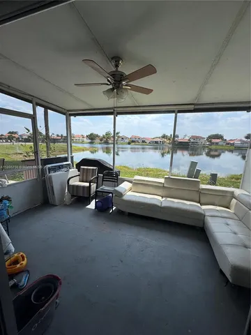 a bathroom with a tub sink and view of living room