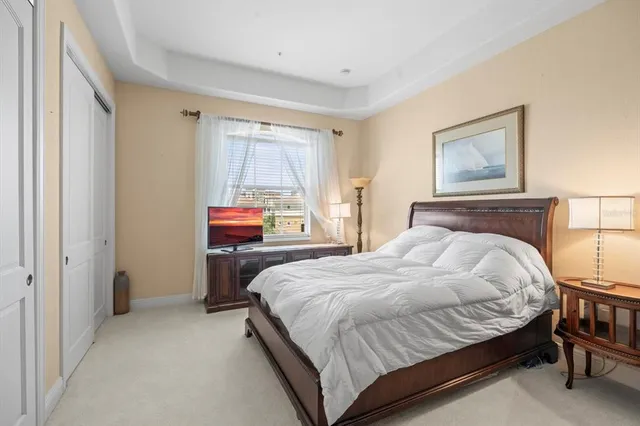 a bedroom with a bed a dresser and with a mirror