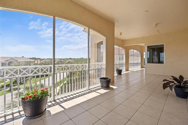 a view of a living room with furniture and floor to ceiling windows