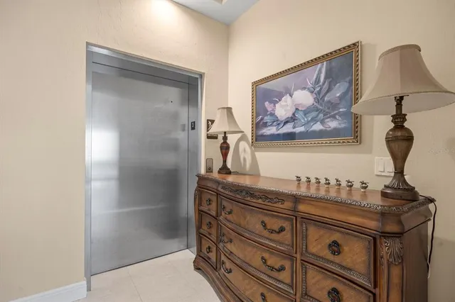 a living room with furniture potted plant and a large window