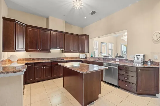 a metallic refrigerator freezer sitting in a kitchen