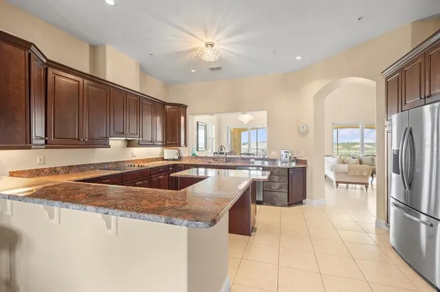 a living room with furniture a flat screen tv and a floor to ceiling window