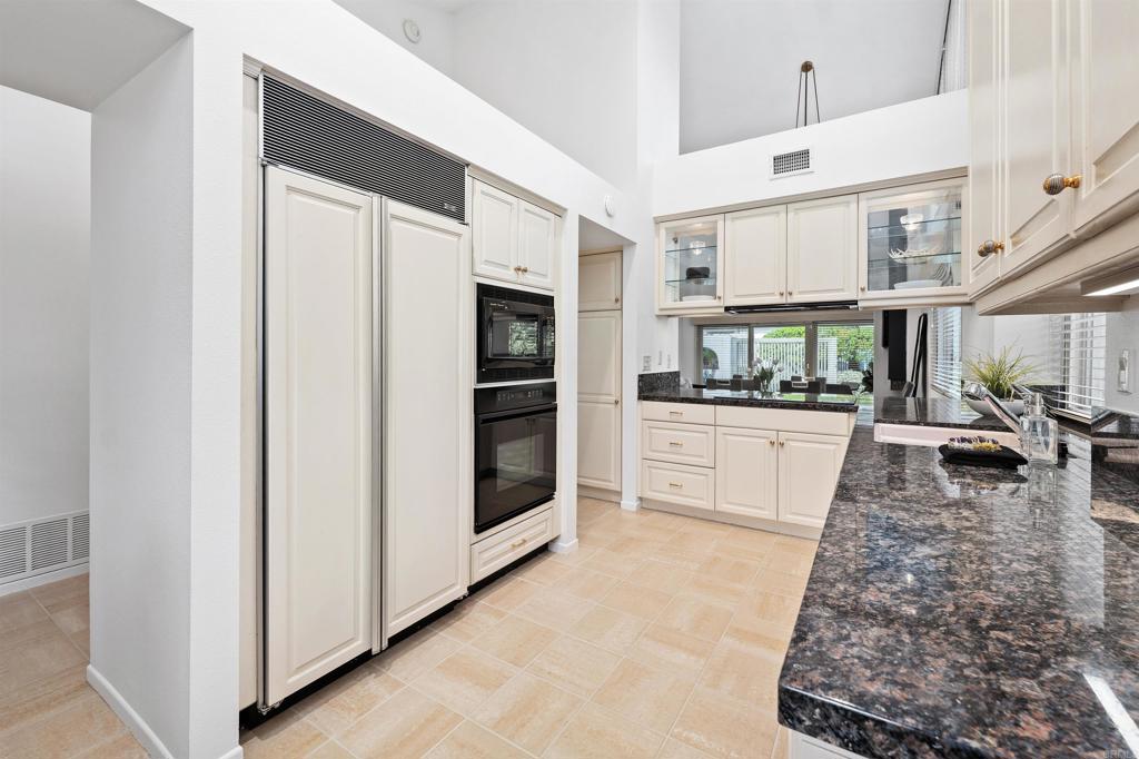 4074 Avenida Brisa Rancho Santa Fe, CA 92091 - Photo 11 of 32 a large white kitchen with cabinets a sink and appliances