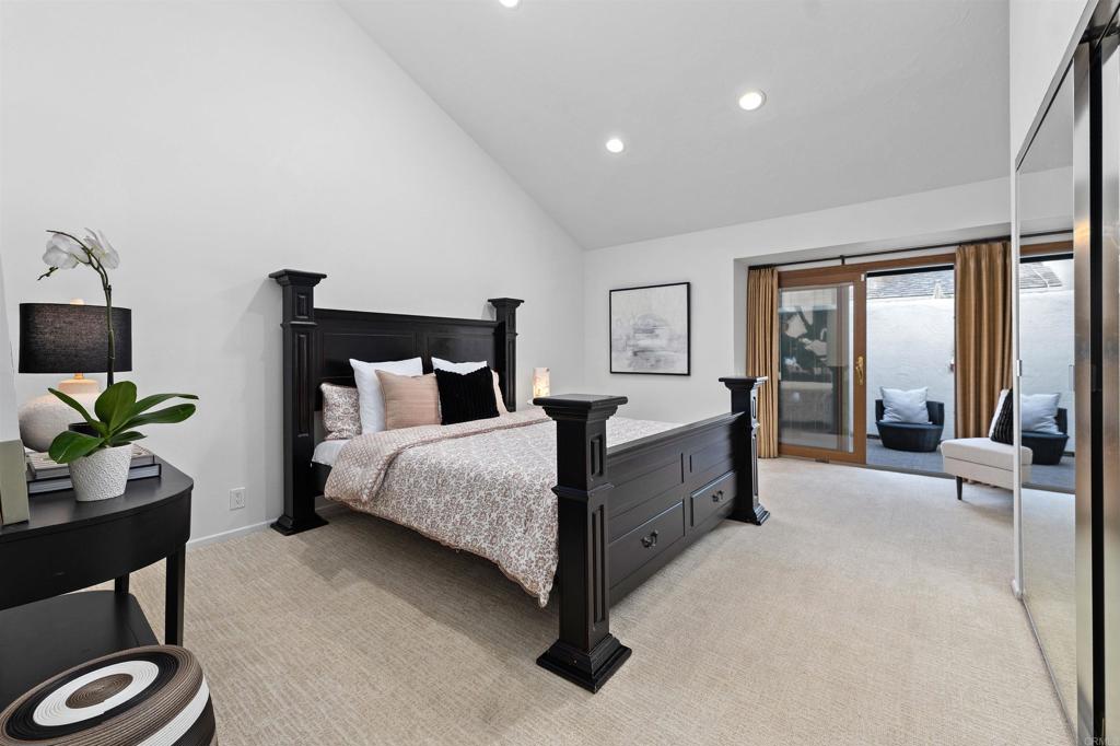 4074 Avenida Brisa Rancho Santa Fe, CA 92091 - Photo 13 of 32 a spacious bedroom with a bed and large windows