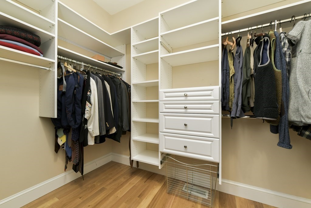 7 Moore Circle, Unit 7 Bedford, MA 01730 - Photo 17 of 27 a view of walk in closet with clothes and shoes