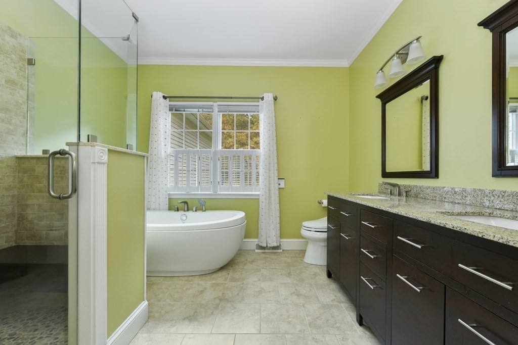 7 Moore Circle, Unit 7 Bedford, MA 01730 - Photo 18 of 27 a bathroom with a sink a bathtub and a shower