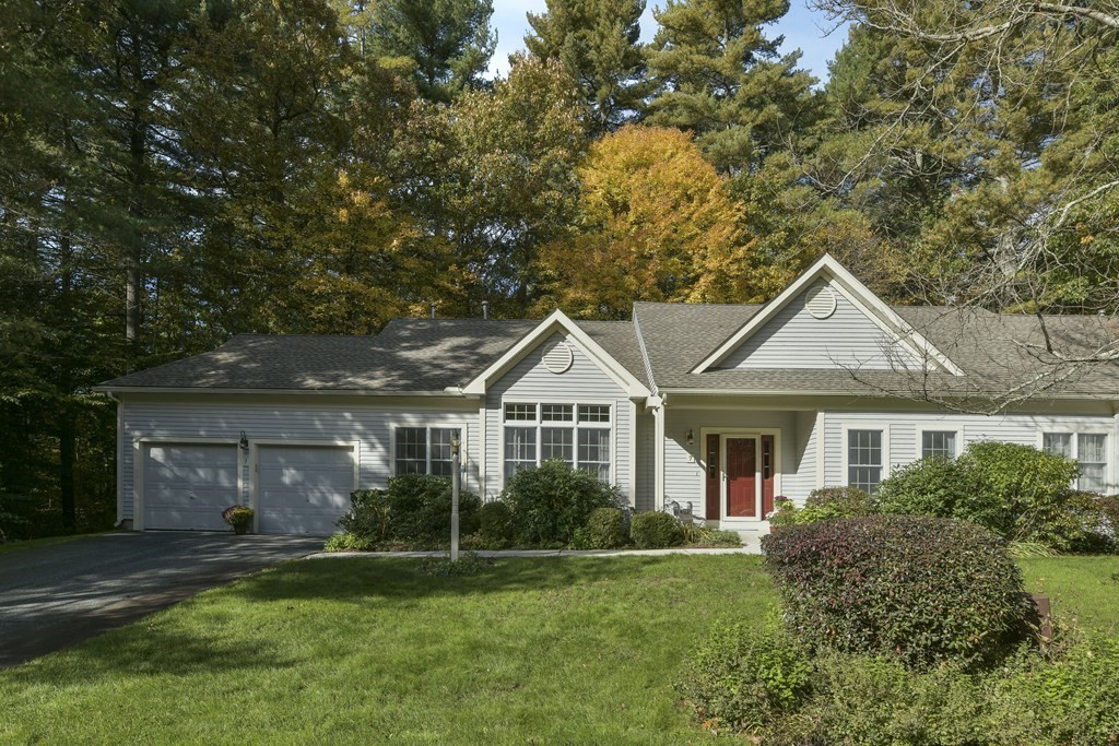 7 Moore Circle, Unit 7 Bedford, MA 01730 - Photo 2 of 27 a front view of a house with a yard and green space
