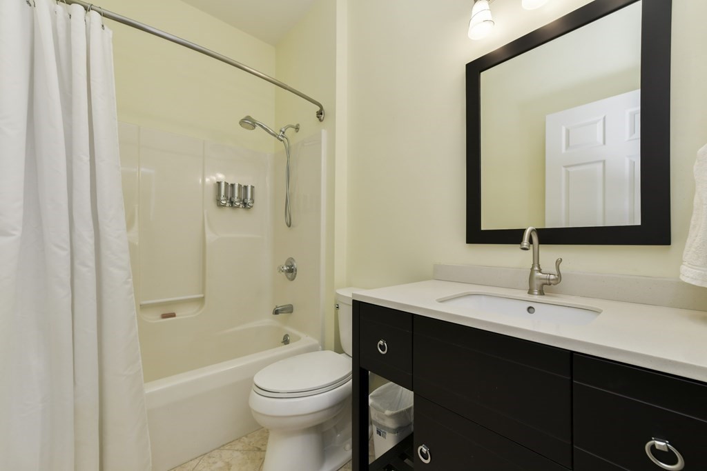 7 Moore Circle, Unit 7 Bedford, MA 01730 - Photo 21 of 27 a bathroom with a sink a toilet and shower