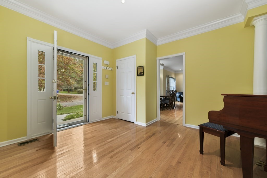 7 Moore Circle, Unit 7 Bedford, MA 01730 - Photo 5 of 27 a view of an empty room with wooden floor and a window