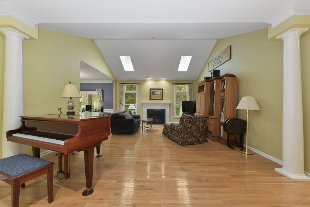 7 Moore Circle, Unit 7 Bedford, MA 01730 - Photo 6 of 27 a living room with furniture and a fireplace