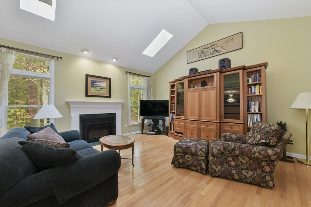 7 Moore Circle, Unit 7 Bedford, MA 01730 - Photo 7 of 27 a living room with furniture and a fireplace