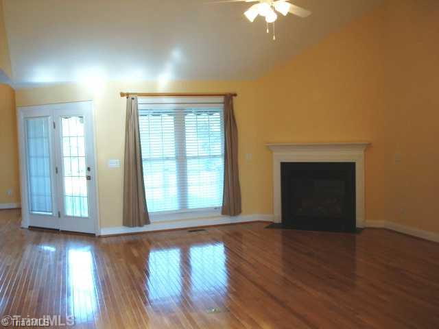 321 Morning Glory Road Madison, NC 27025 - Photo 3 of 16 Den/Family/Great Room. Open & light Great room with cathedral ceiling, gas log fireplace and french doors leading to patio.