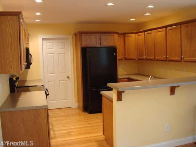 321 Morning Glory Road Madison, NC 27025 - Photo 5 of 16 Kitchen. Functional Kitchen includes large pantry, hardwood floor, recessed lighting and breakfast bar.