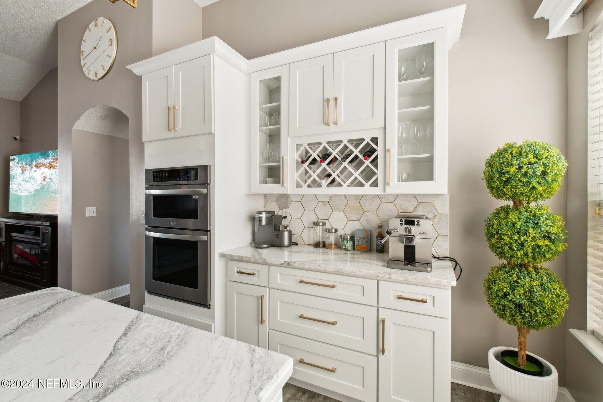 2955 Ravine Hill Drive Middleburg, FL 32068 - Photo 11 of 38 a kitchen with stainless steel appliances kitchen island granite countertop a refrigerator a stove a sink and a stove