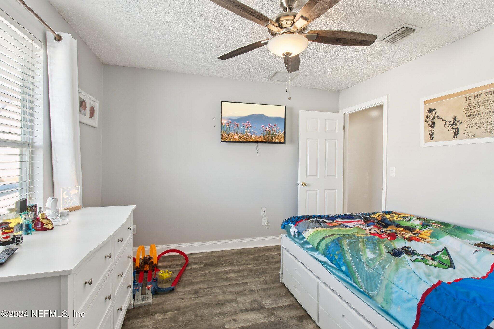 2955 Ravine Hill Drive Middleburg, FL 32068 - Photo 25 of 38 a bedroom with a bed and a chandelier