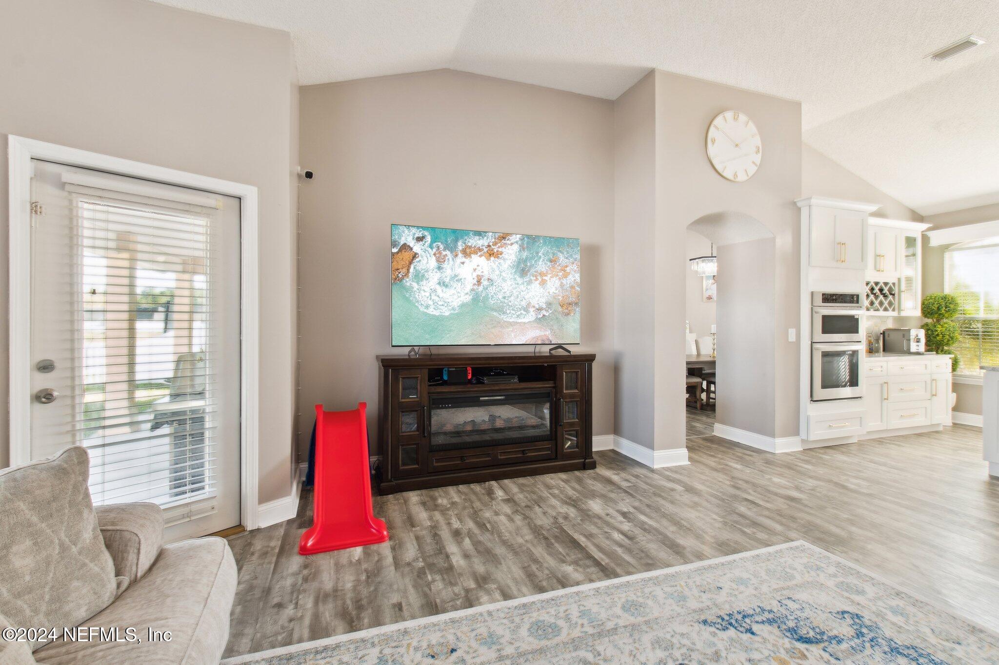 2955 Ravine Hill Drive Middleburg, FL 32068 - Photo 26 of 38 a living room with furniture and a flat screen tv