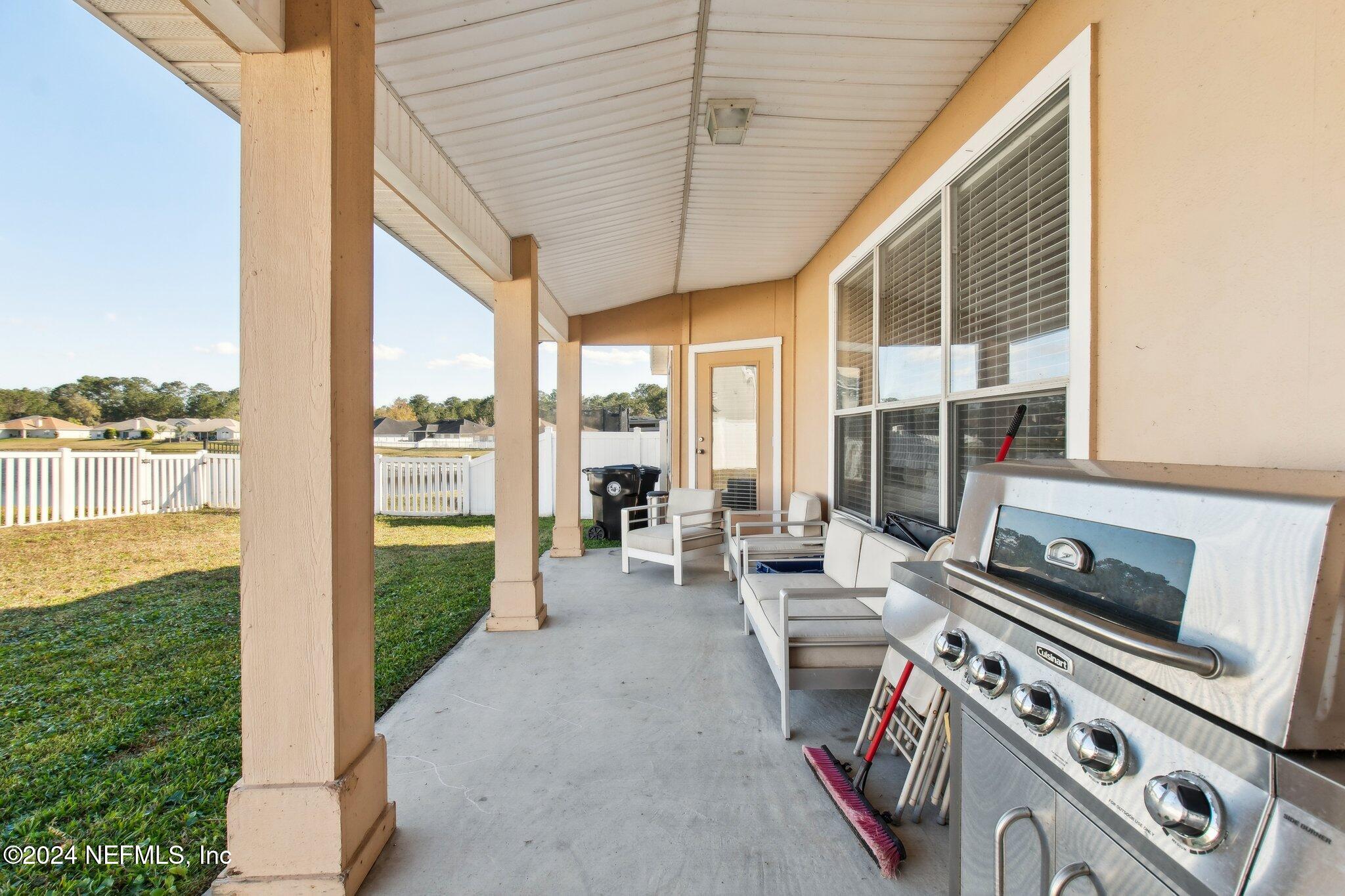 2955 Ravine Hill Drive Middleburg, FL 32068 - Photo 32 of 38 a view of a patio with table and chairs and potted plants