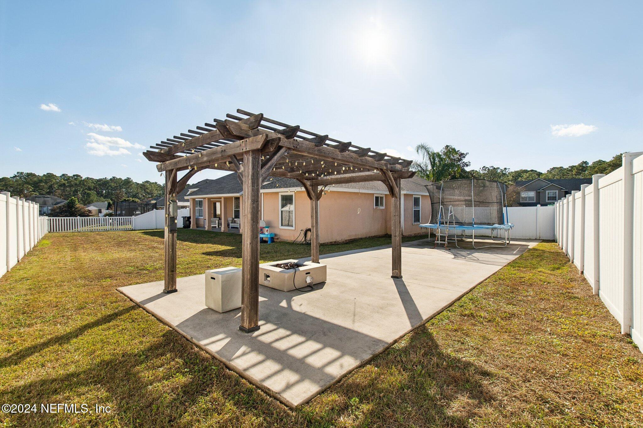 2955 Ravine Hill Drive Middleburg, FL 32068 - Photo 37 of 38 a view of a swimming pool with a chair and tables in the patio