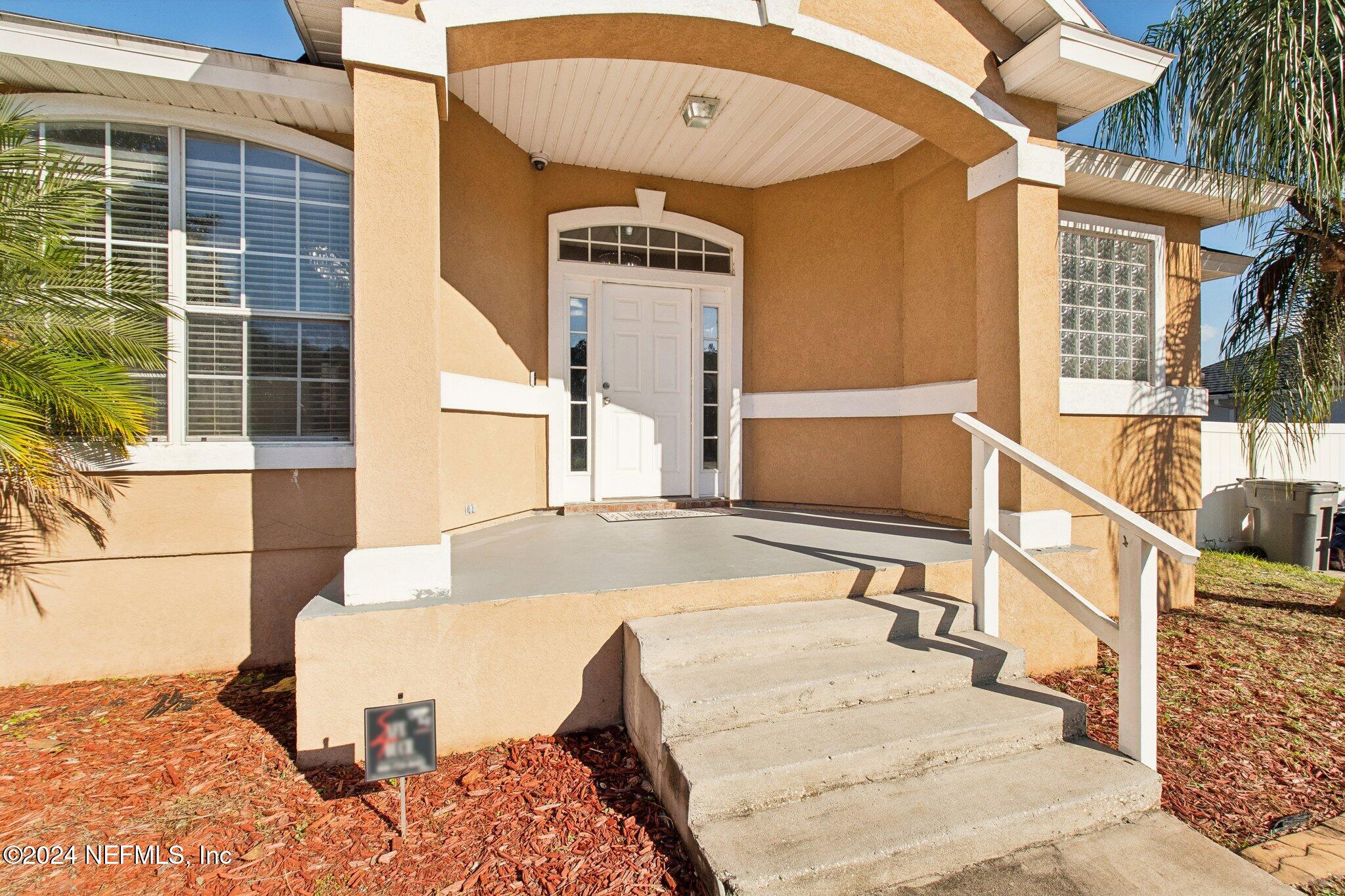 2955 Ravine Hill Drive Middleburg, FL 32068 - Photo 5 of 38 a view of a balcony with furniture and floor to ceiling window