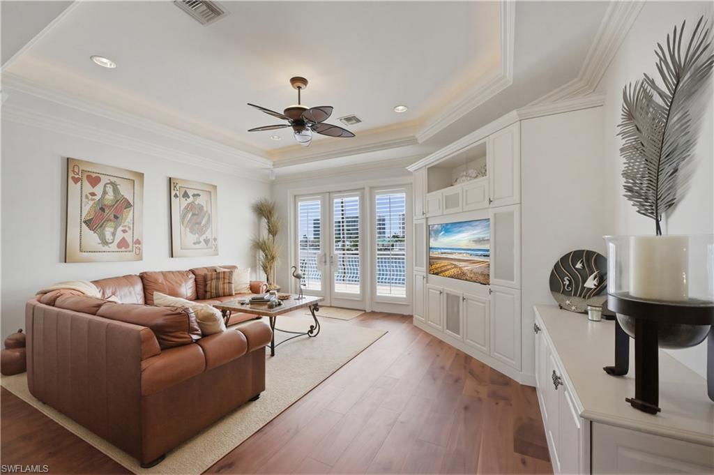 361 Pirates Bight Naples, FL 34103 - Photo 27 of 45 a living room with furniture and a flat screen tv