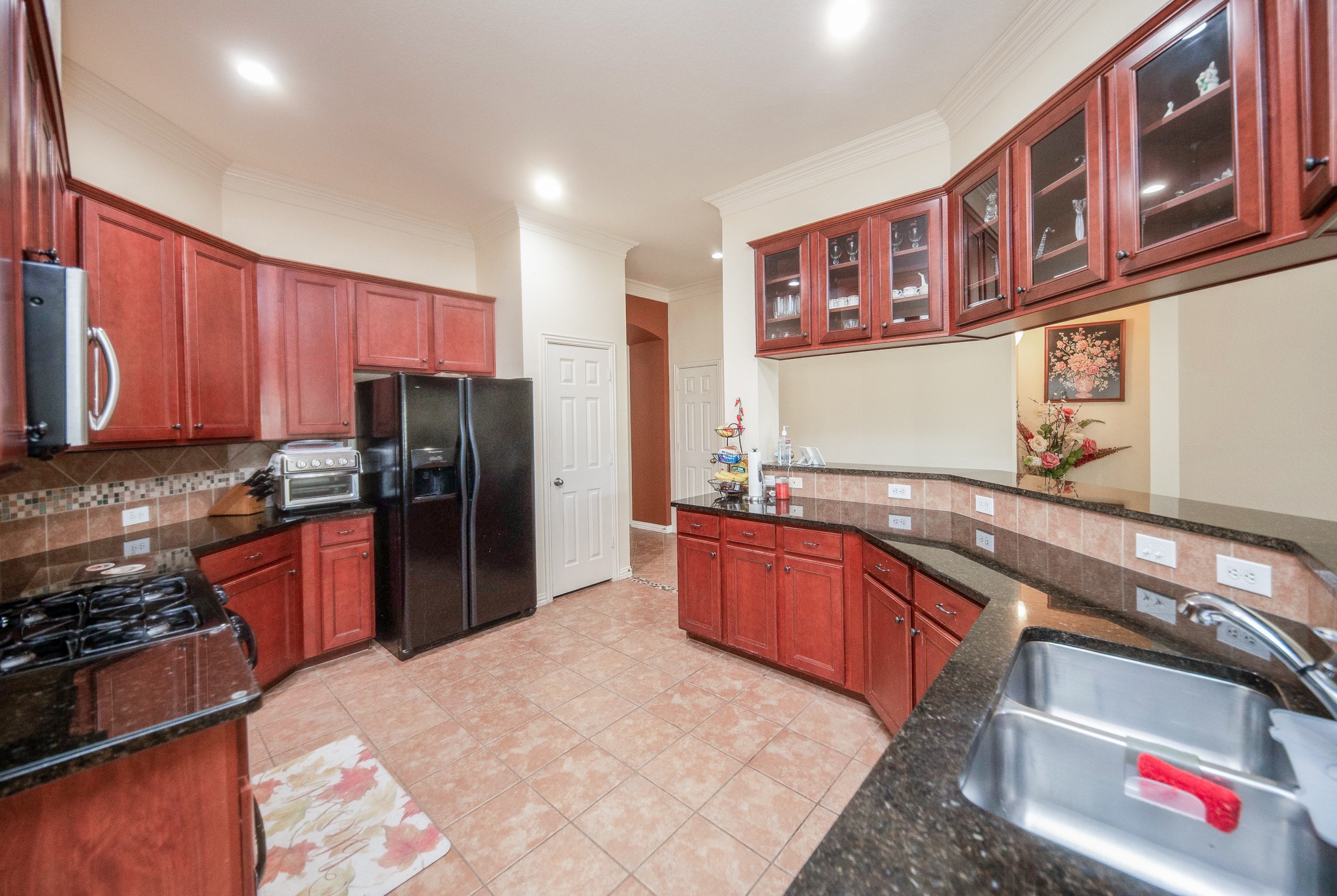 9034 Necklace Tree Lane Katy, TX 77494 - Photo 12 of 33 a kitchen with stainless steel appliances granite countertop a refrigerator and a stove top oven