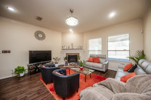 a living room with furniture a fireplace and a flat screen tv