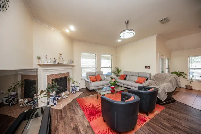 a living room with furniture a fireplace and a window