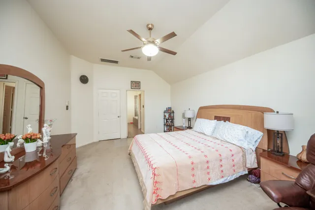 a bedroom with a bed and lamp