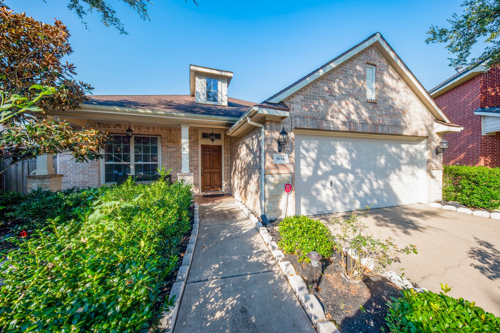 9034 Necklace Tree Lane Katy, TX 77494 - Photo 2 of 33 a front view of a house with garden
