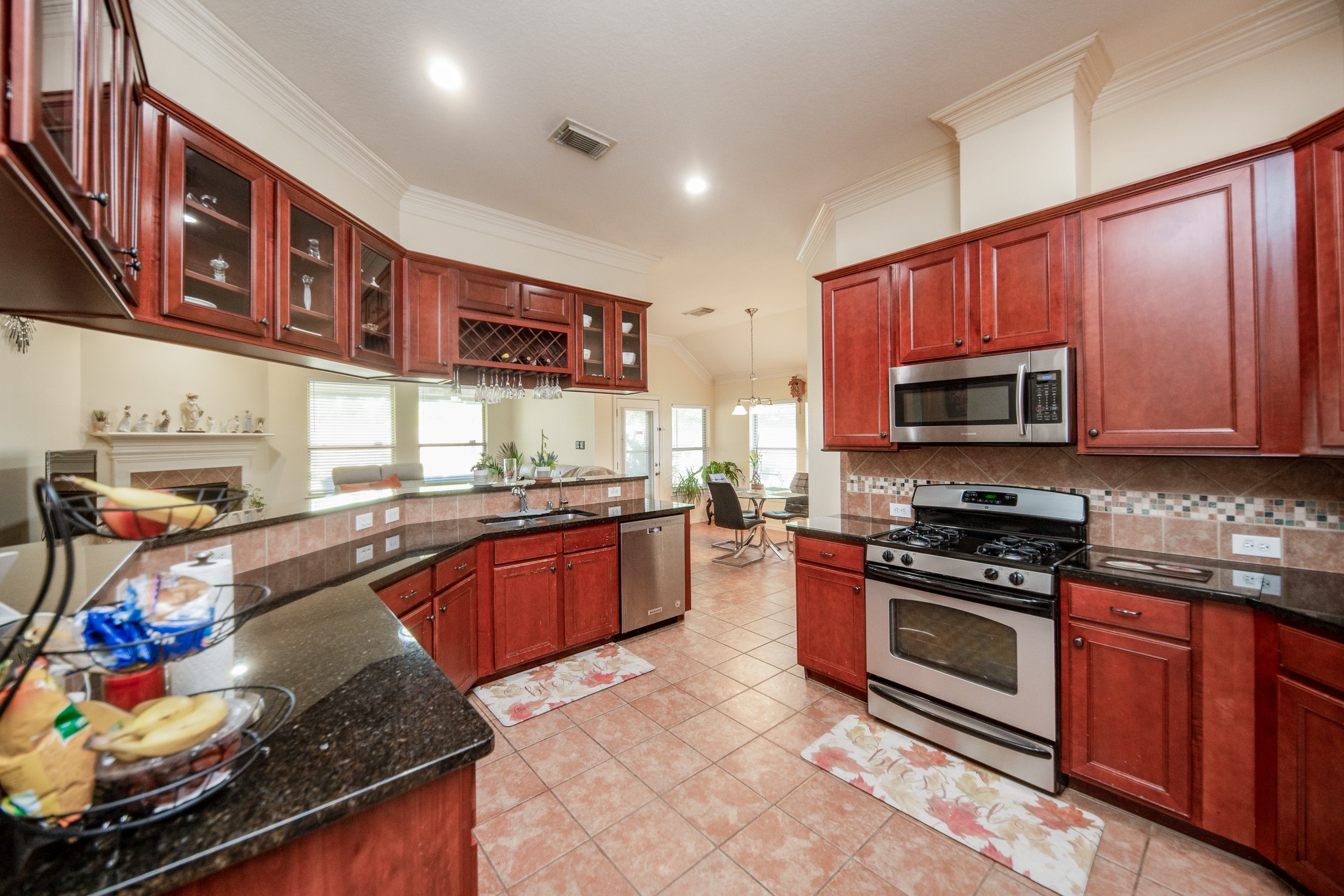 9034 Necklace Tree Lane Katy, TX 77494 - Photo 10 of 33 a kitchen with stainless steel appliances granite countertop a stove top oven a sink dishwasher and cabinets with wooden floor