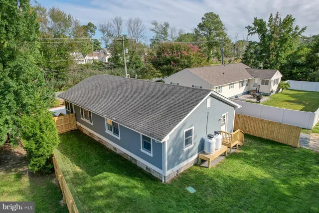 an aerial view of a house with a yard table and chairs