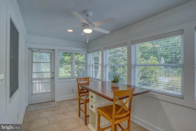 a workspace room with furniture and windows