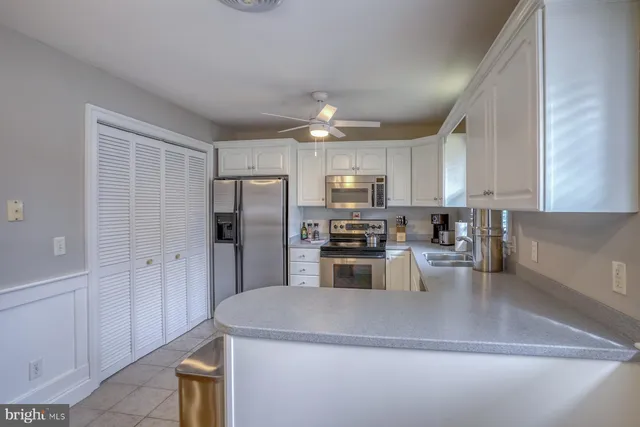 a kitchen with refrigerator and cabinets