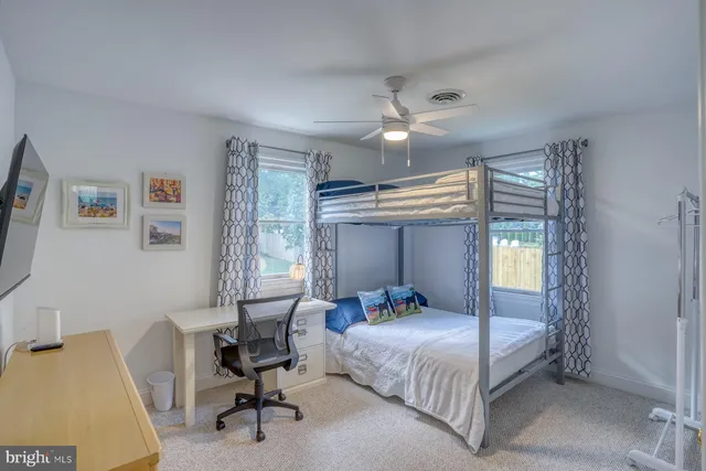 a bedroom with a bed and a desk