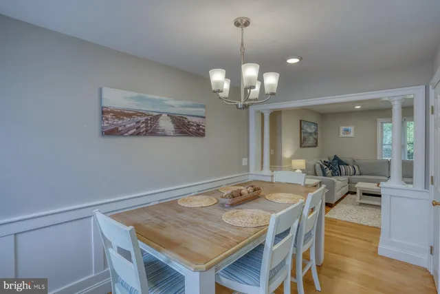 a view of a dining room with furniture wooden floor and chandelier