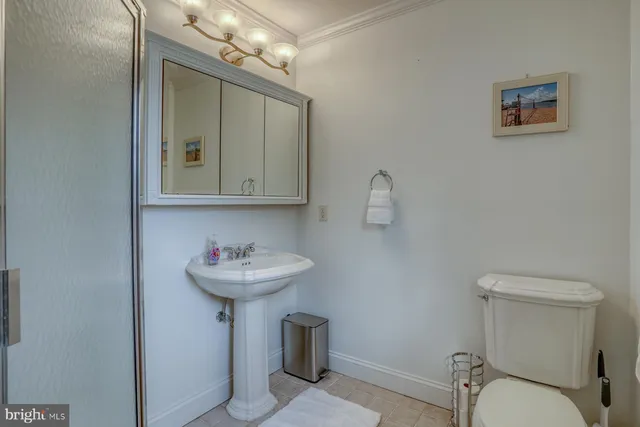 a bathroom with a sink mirror and toilet