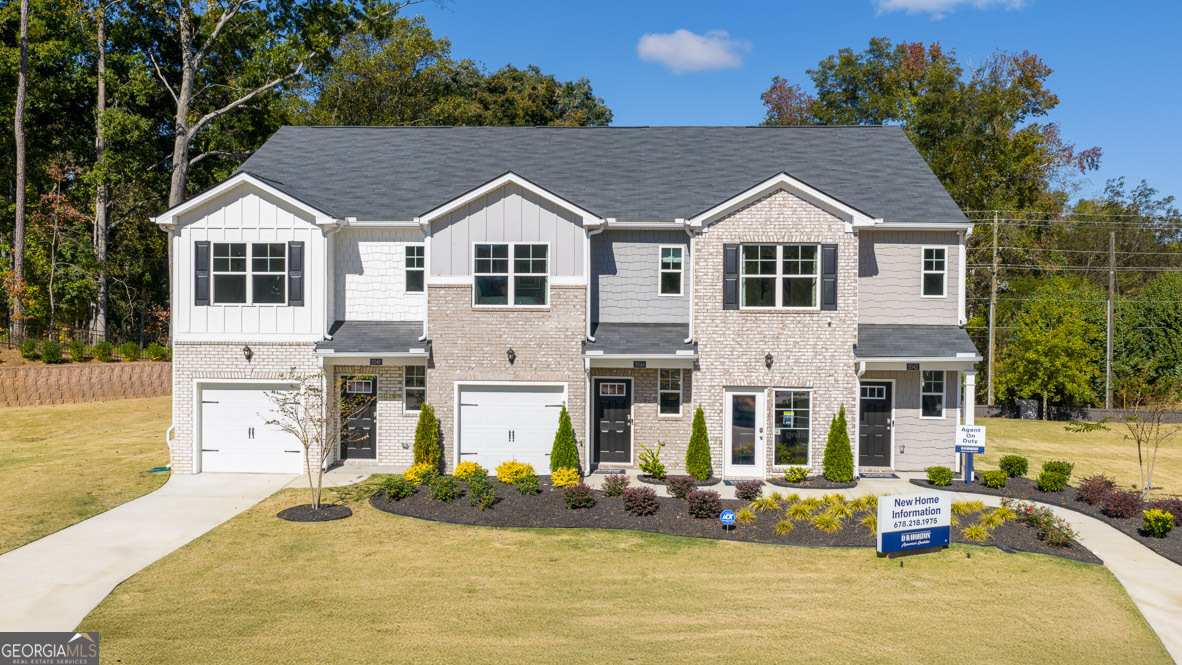2086 Moss Hill Road Stone Mountain, GA 30088 - Photo 1 of 38 a view of a white house with table and chairs