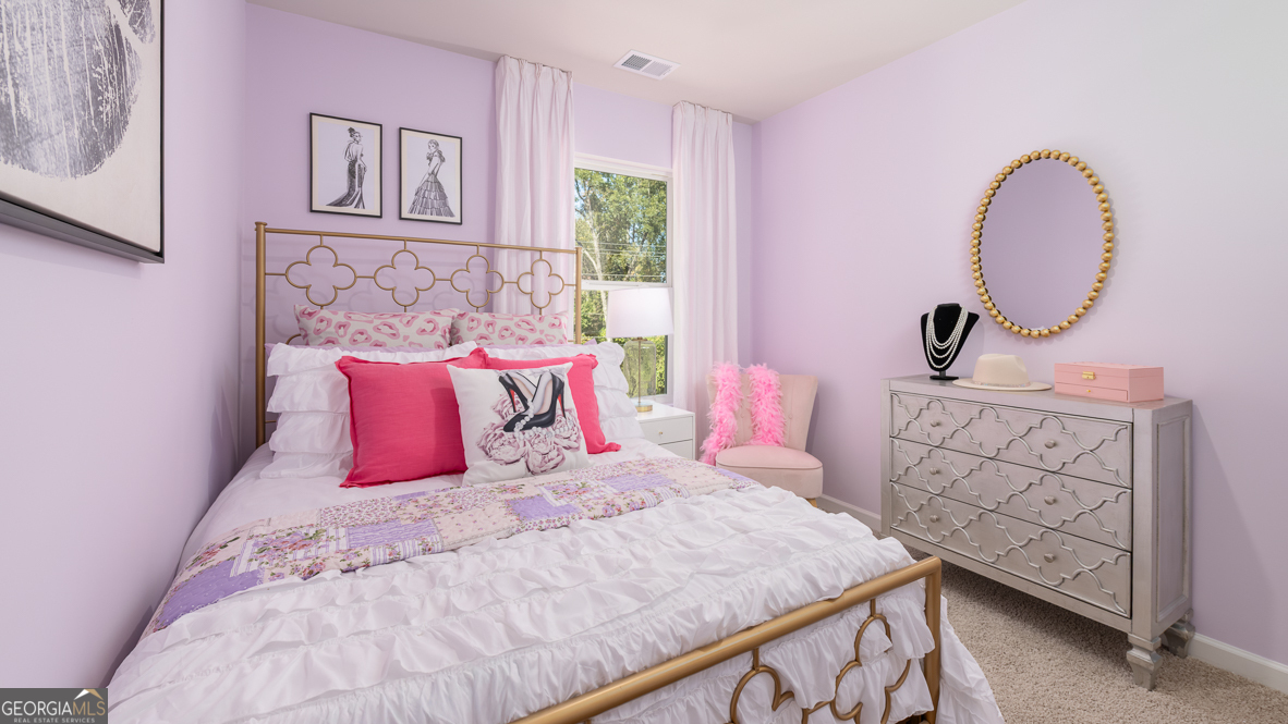 2086 Moss Hill Road Stone Mountain, GA 30088 - Photo 31 of 38 a bedroom with a bed a dresser with wooden floor