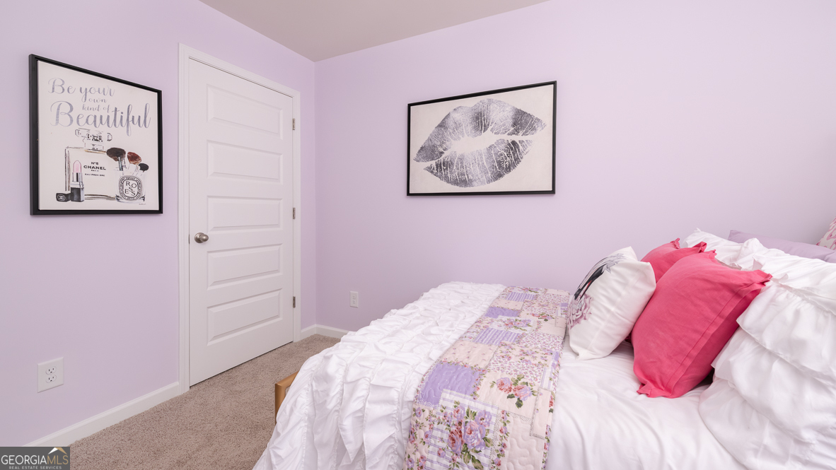 2086 Moss Hill Road Stone Mountain, GA 30088 - Photo 32 of 38 a bedroom with a bed and a painting on the wall